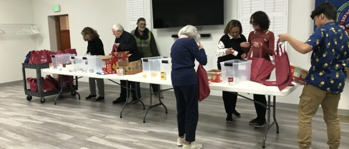 Trinity Church members pack bags for Backpack Blessings food ministry